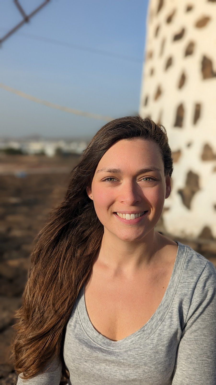 Portrait of Judy Turcotte, social worker, smiling in warm evening light